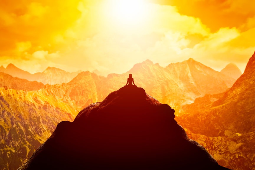 woman meditating in sitting yoga position on the top of a mountains above clouds at sunset 2