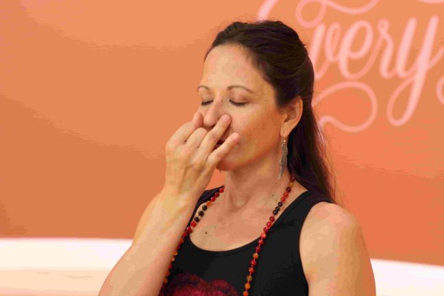 Woman doing Alternate Nostril Breathing