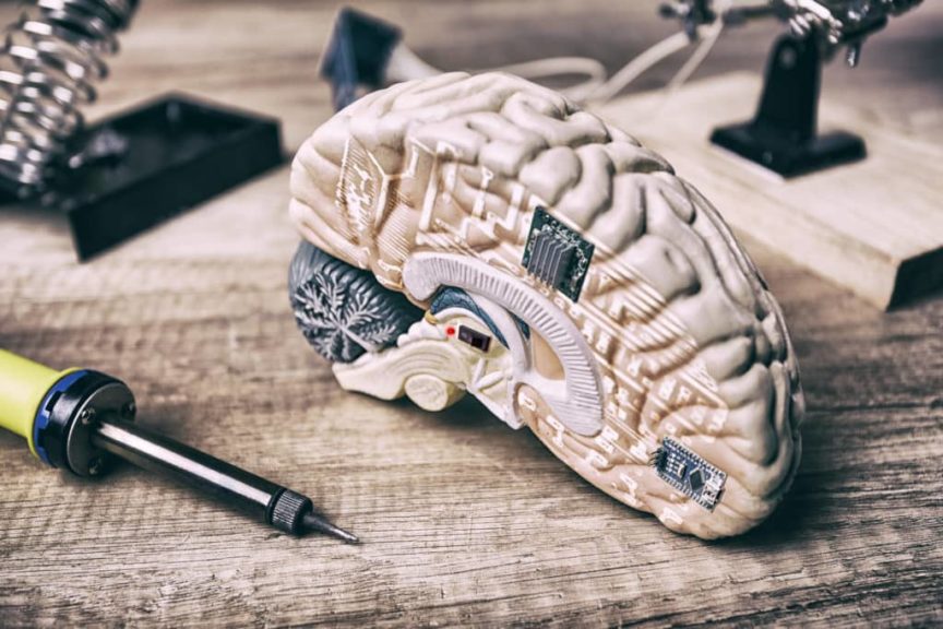 Left hemisphere of a brain with lamps, chips, and wires