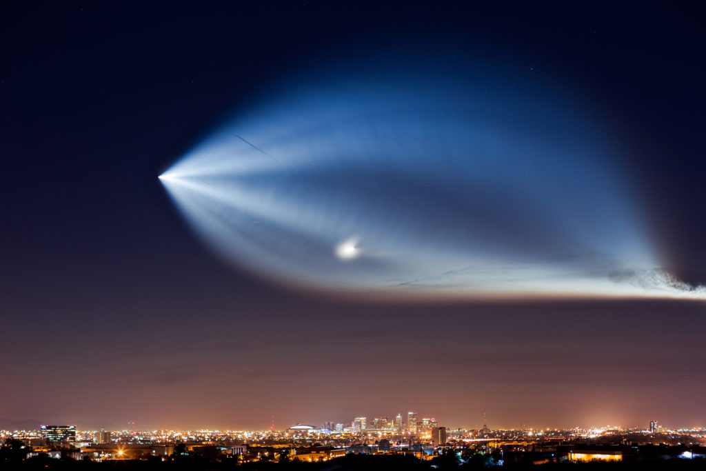 spacex falcon 9 rocket launch from vandenberg air force base over the downtown phoenix skyline phoenix usa