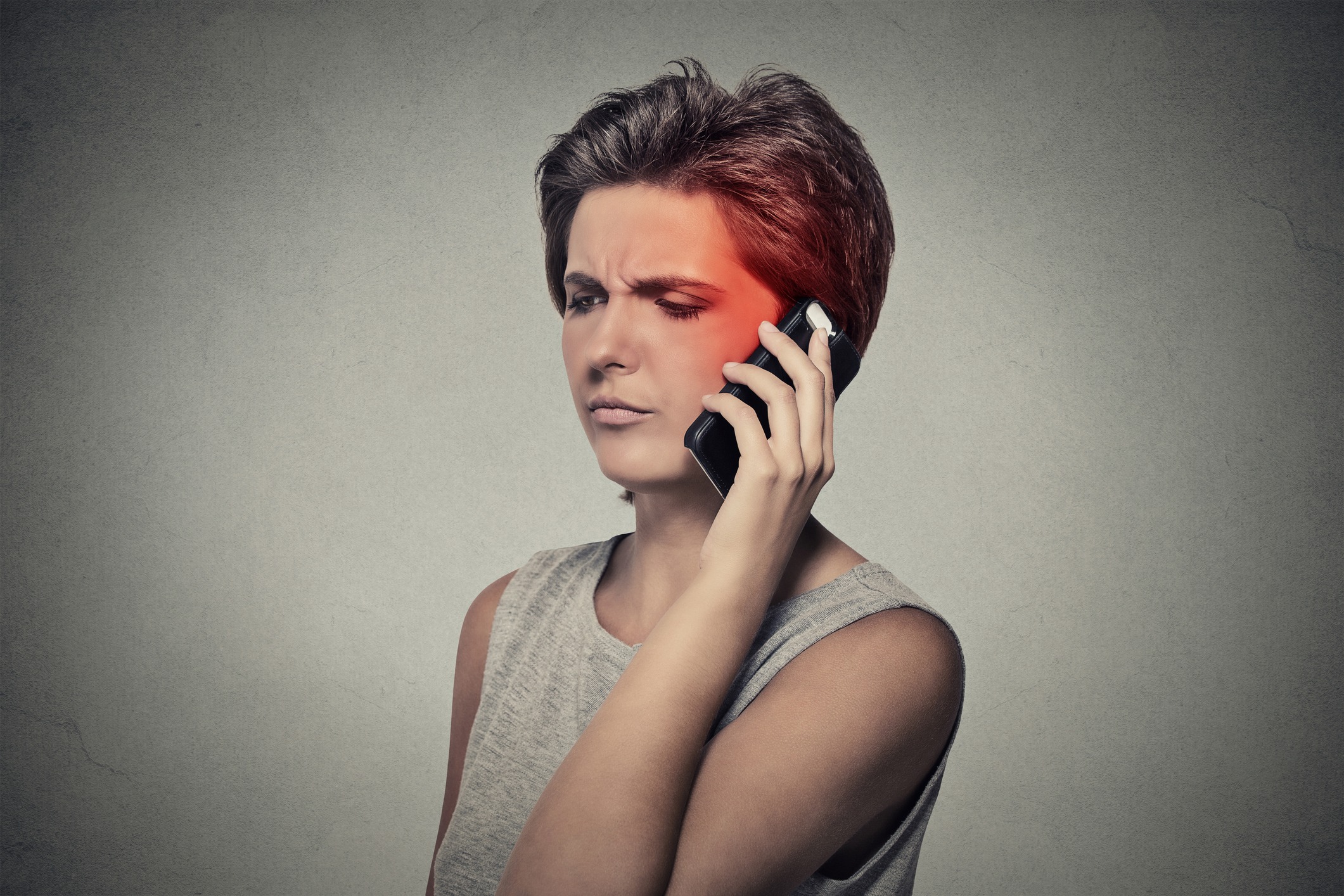 girl on the phone with headache cellular mobile radiation concept